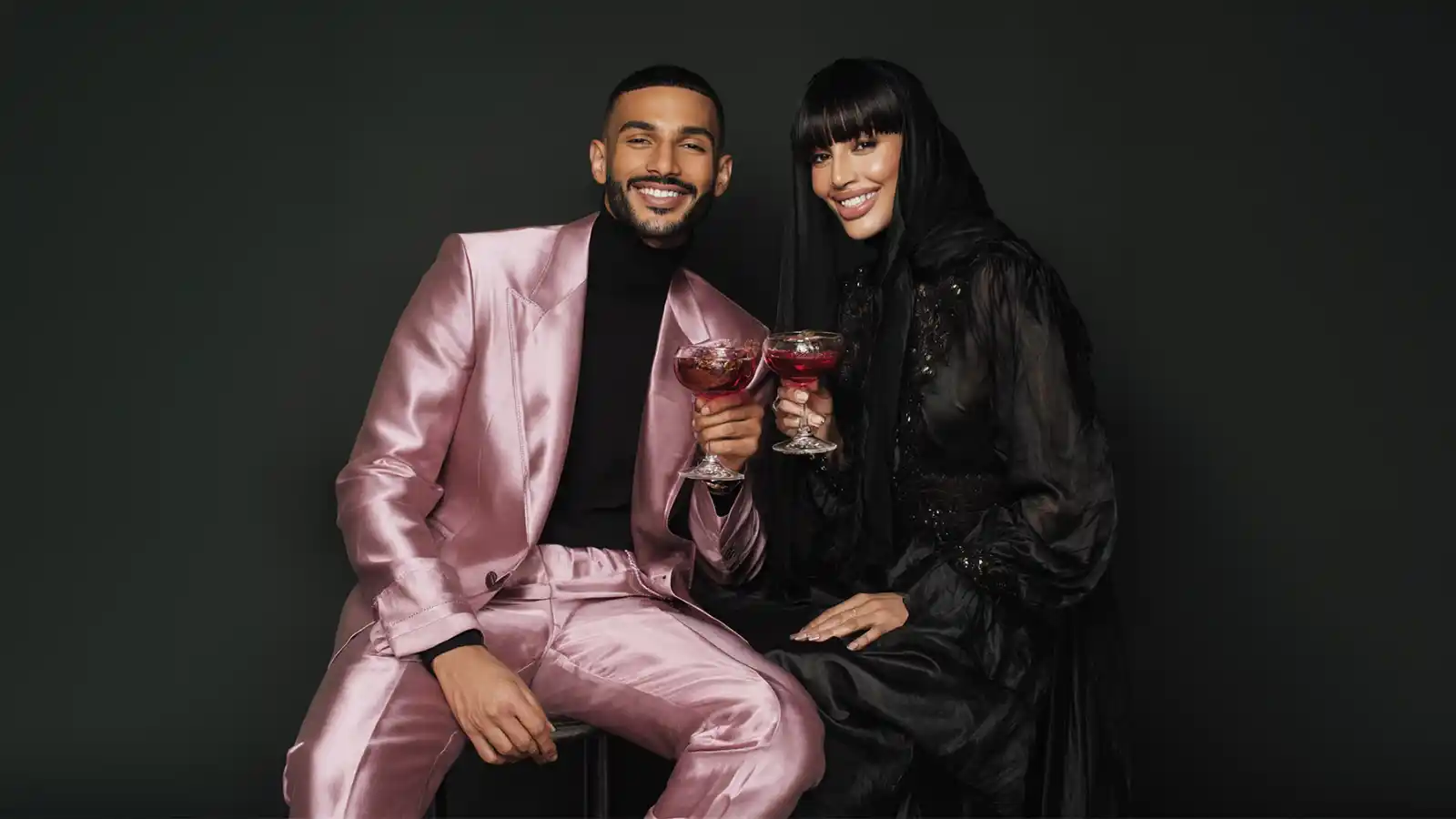 Stylish couple holding non-alcoholic drinks for a refined late-night Bradford nightlife story